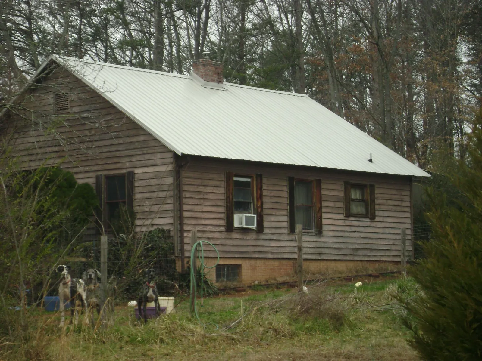 White metal roof on an old wood sided farmhouse, from a Metal Roof Installation job in Exeter